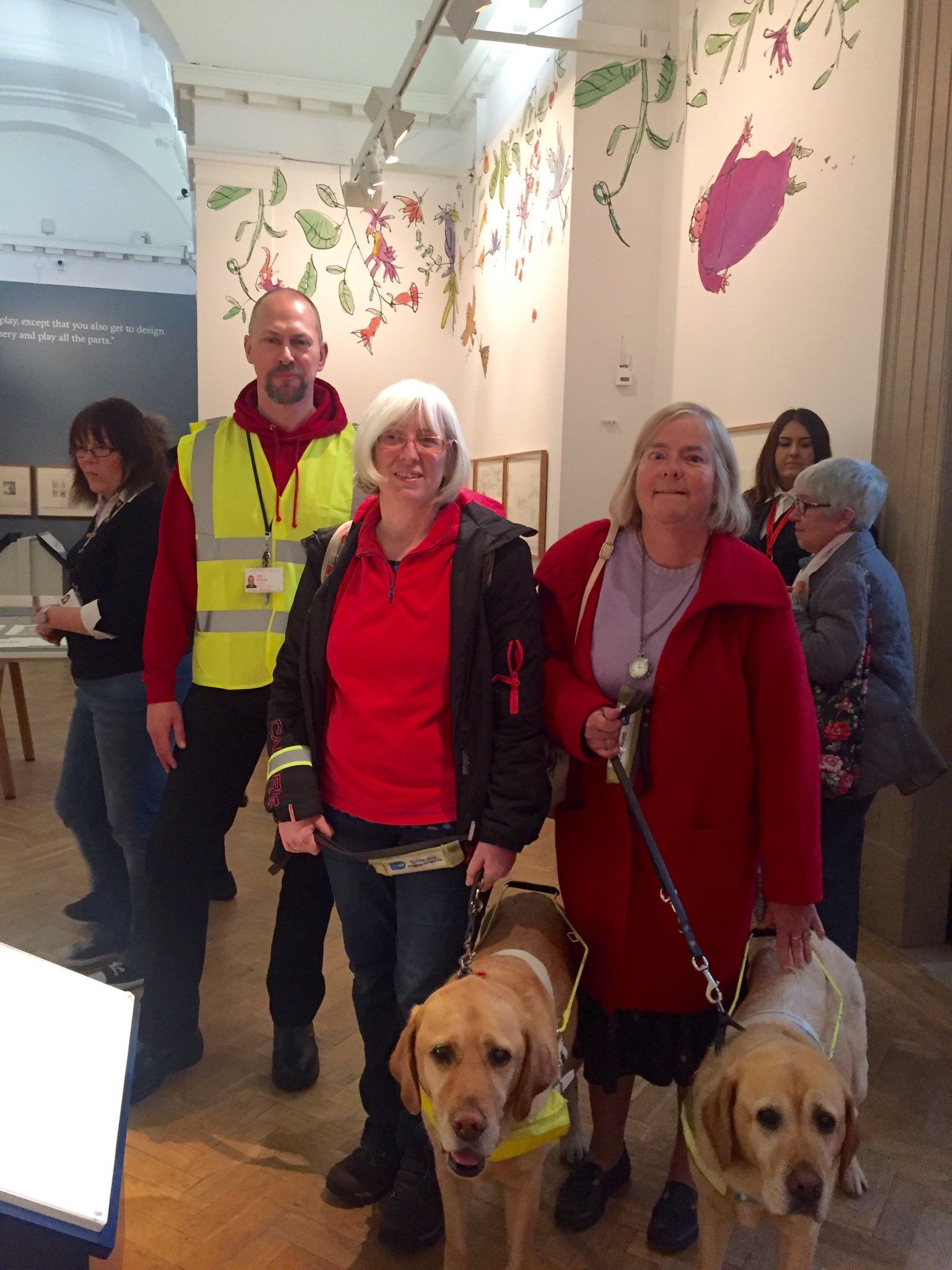 Photograph of two ladies with guide dogs and a member of museum staff
