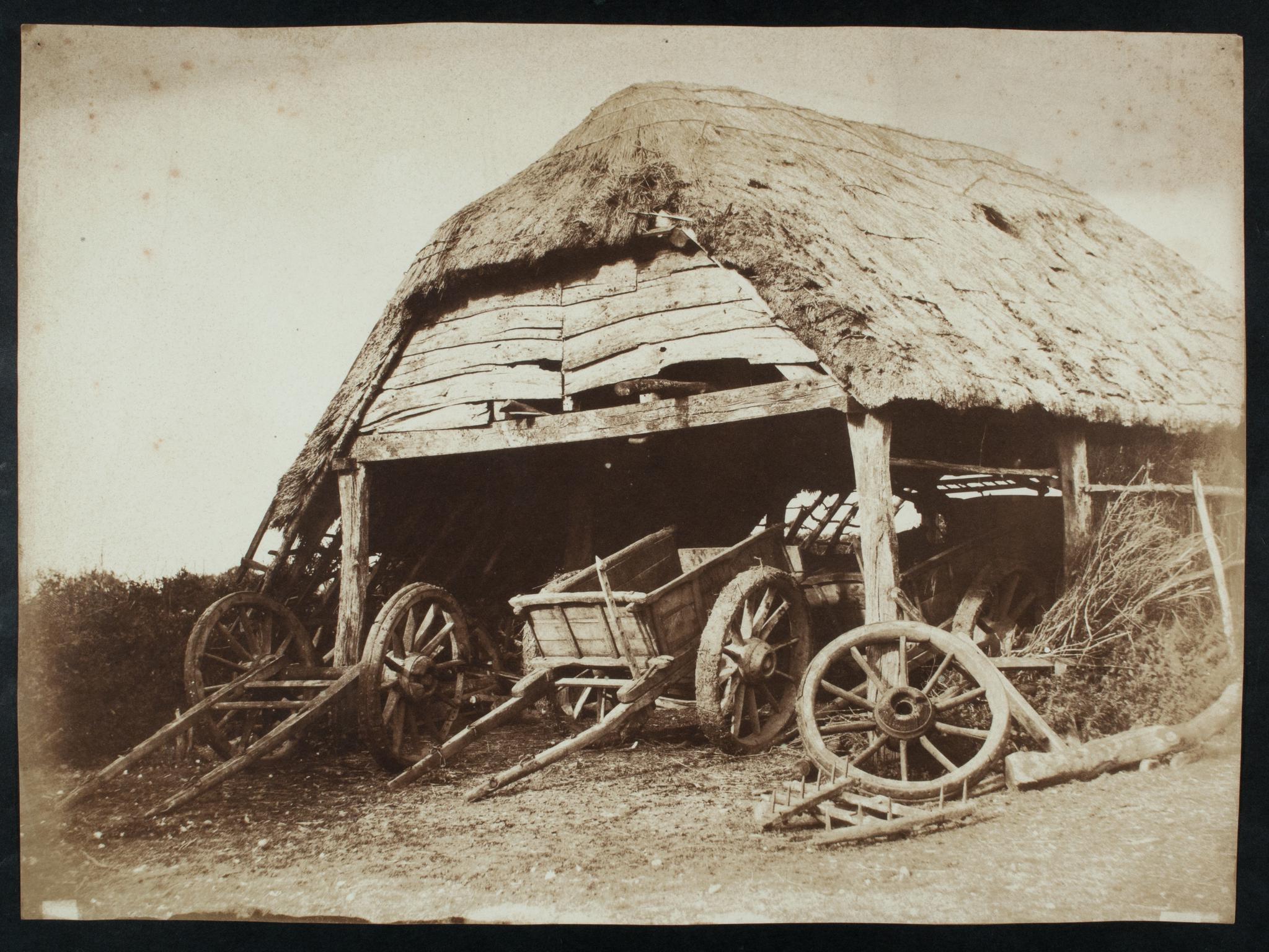 Open sided barn with wagons, photograph