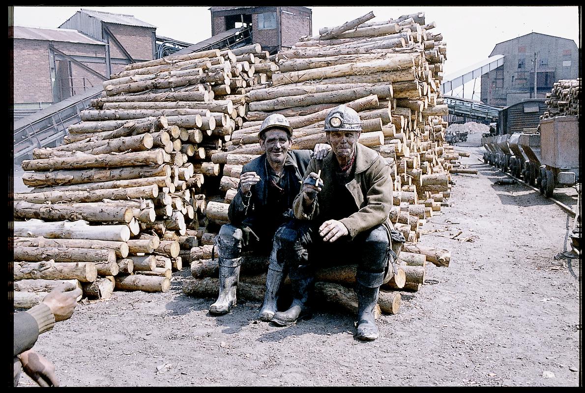 Two miners having a cigarette in the timber yard, Big Pit Colliery