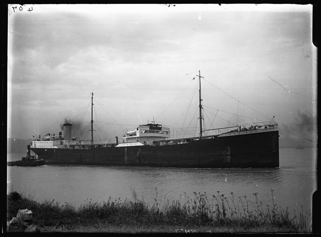 Starboard broadside view of M.V. CIRCE SHELL and tug, c.1936.