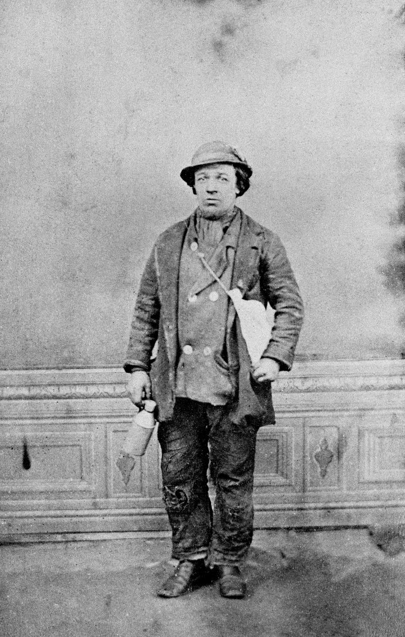 Colliery worker holding a food bag and &#039;water jack&#039;.