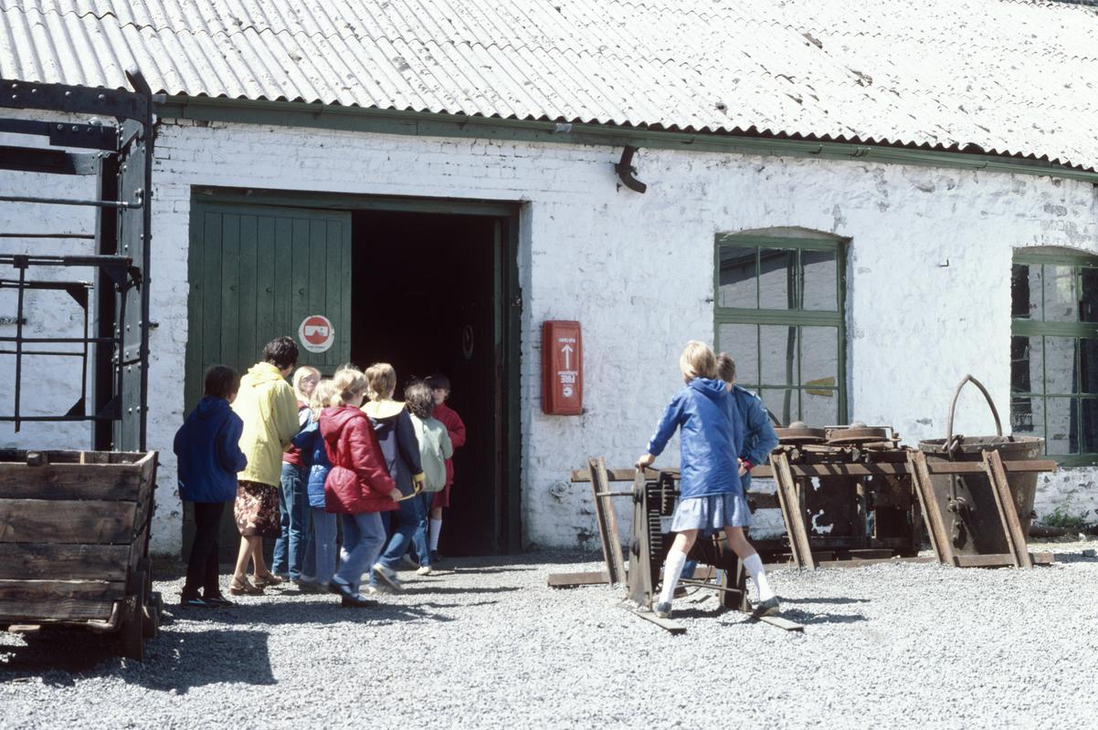 Visitors outside the blacksmiths shop at Big Pit