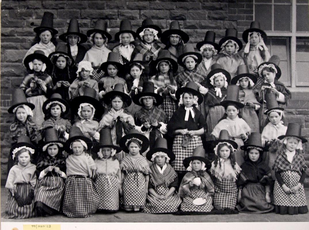 A group of Pontrhondda School schoolgirls pose in traditional welsh dress outside their classroom on St David&#039;s Day 1915.