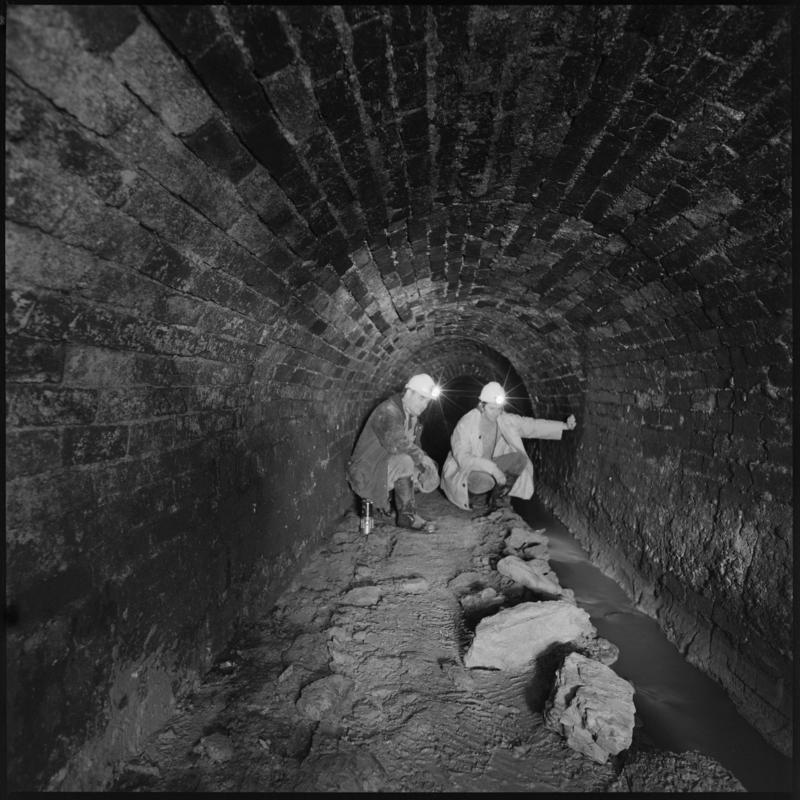 Black and white film negative showing  two men at River Arch, Big Pit Colliery.