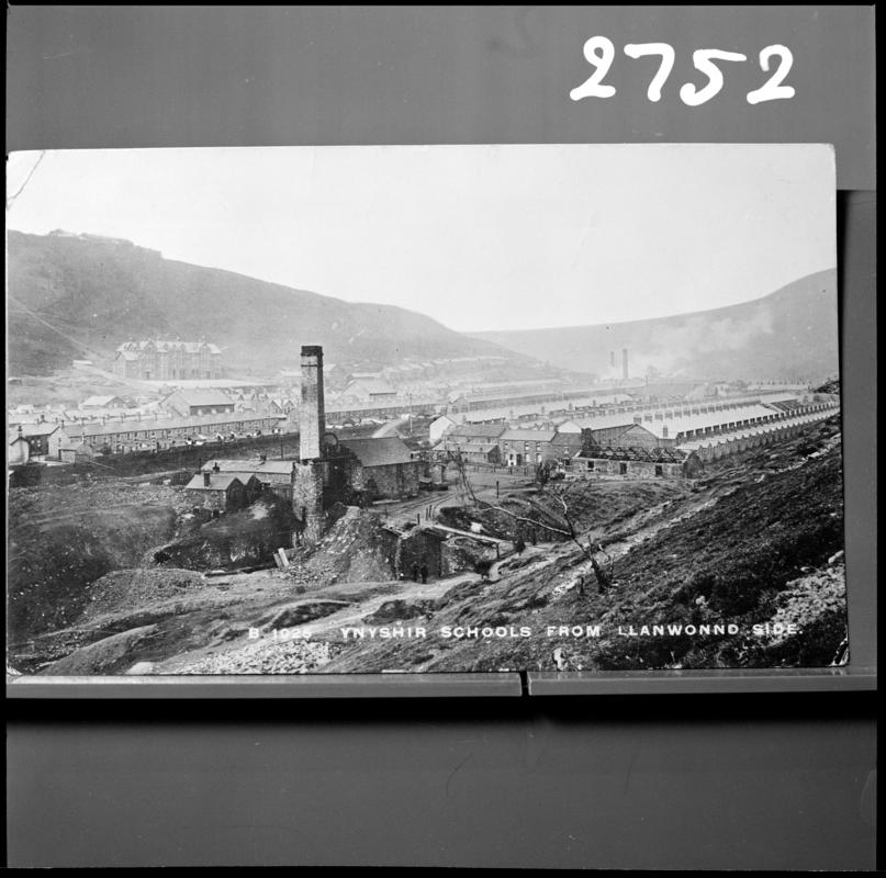 Black and white film negative of a photograph showing a surface view of Jones Pit, Ynyshir 1905.  Standard Colliery is in the background.  Caption at the bottom of the image states &#039;Ynyshir schools from Llanwonno side&#039;&#039;