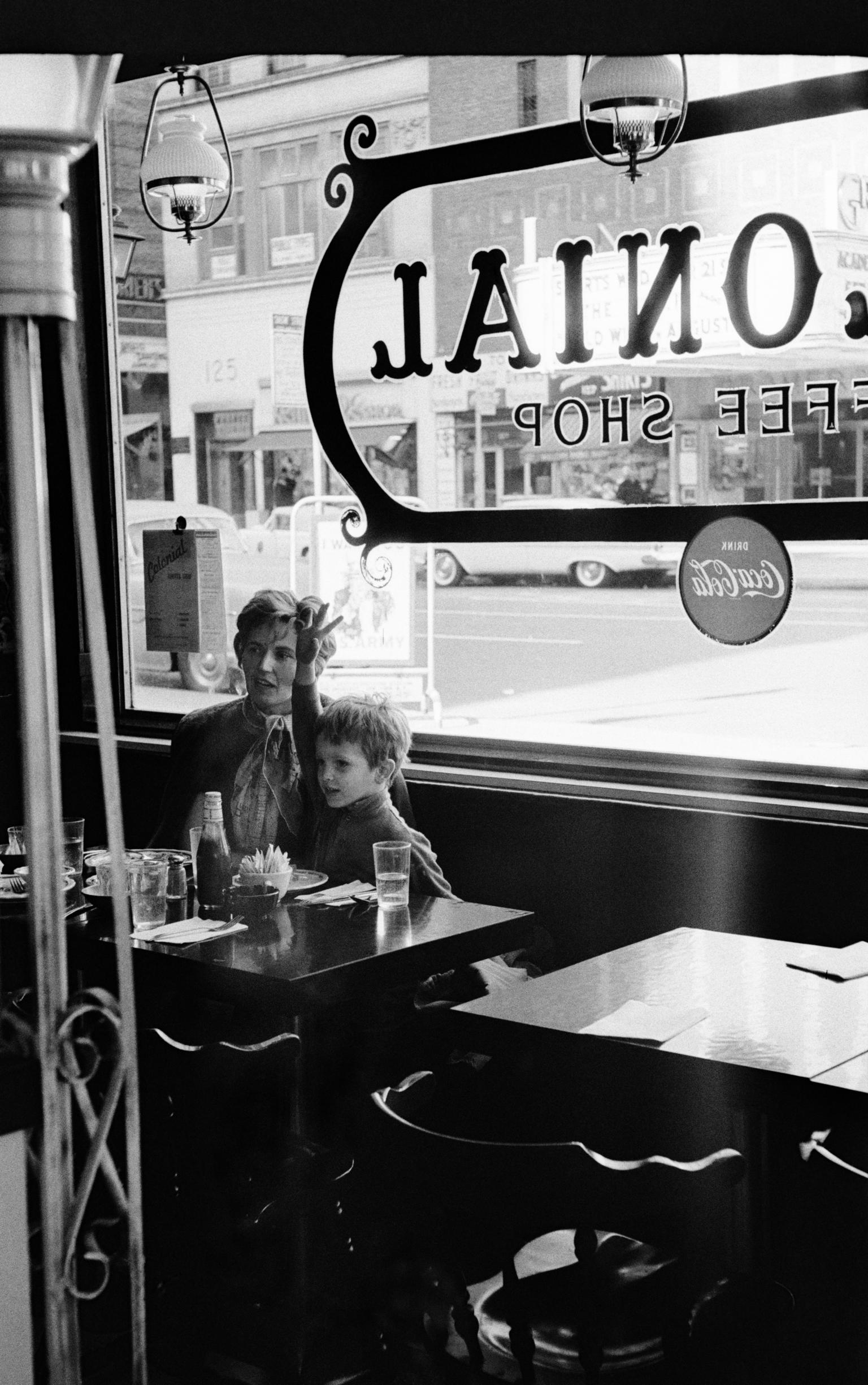 Wave in a cafe. Mother and child. New York USA
