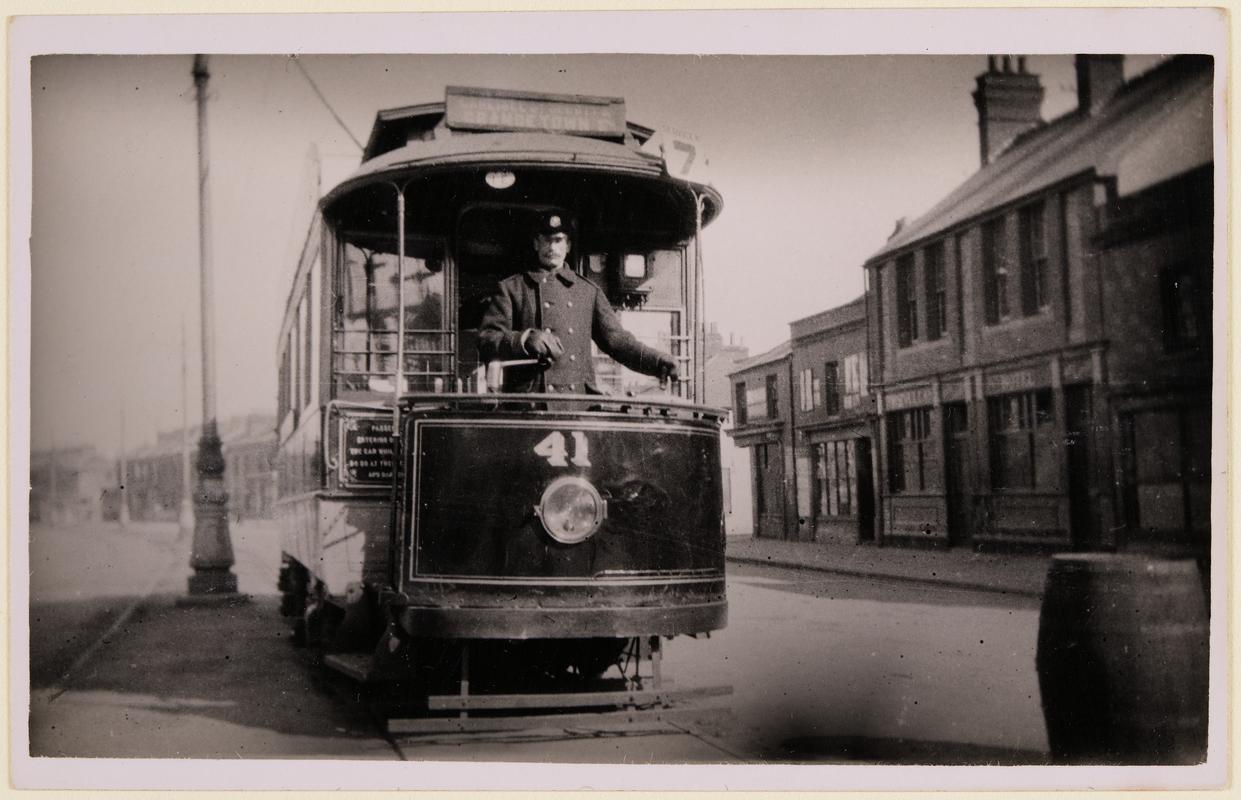 ‘Single deck car No. 41 on Service 7 (Carlisle St, Splott and Grangetown) in Adam Street 1919. Driver Middleton is at the controls and the photograph was taken by E. Bowden, Inspector C.C.T. The Vulcan Hotel is seen on the right&#039;.