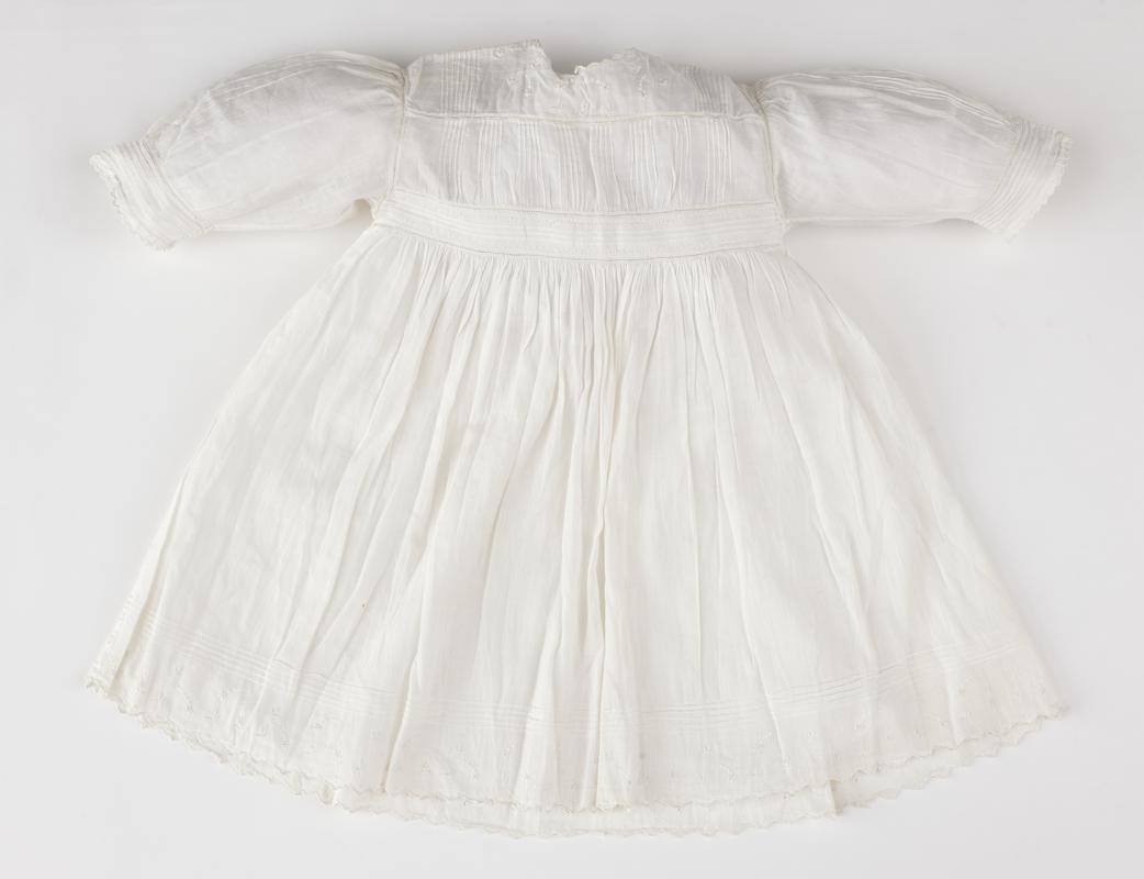 Baby&#039;s white cambric frock with high waistline