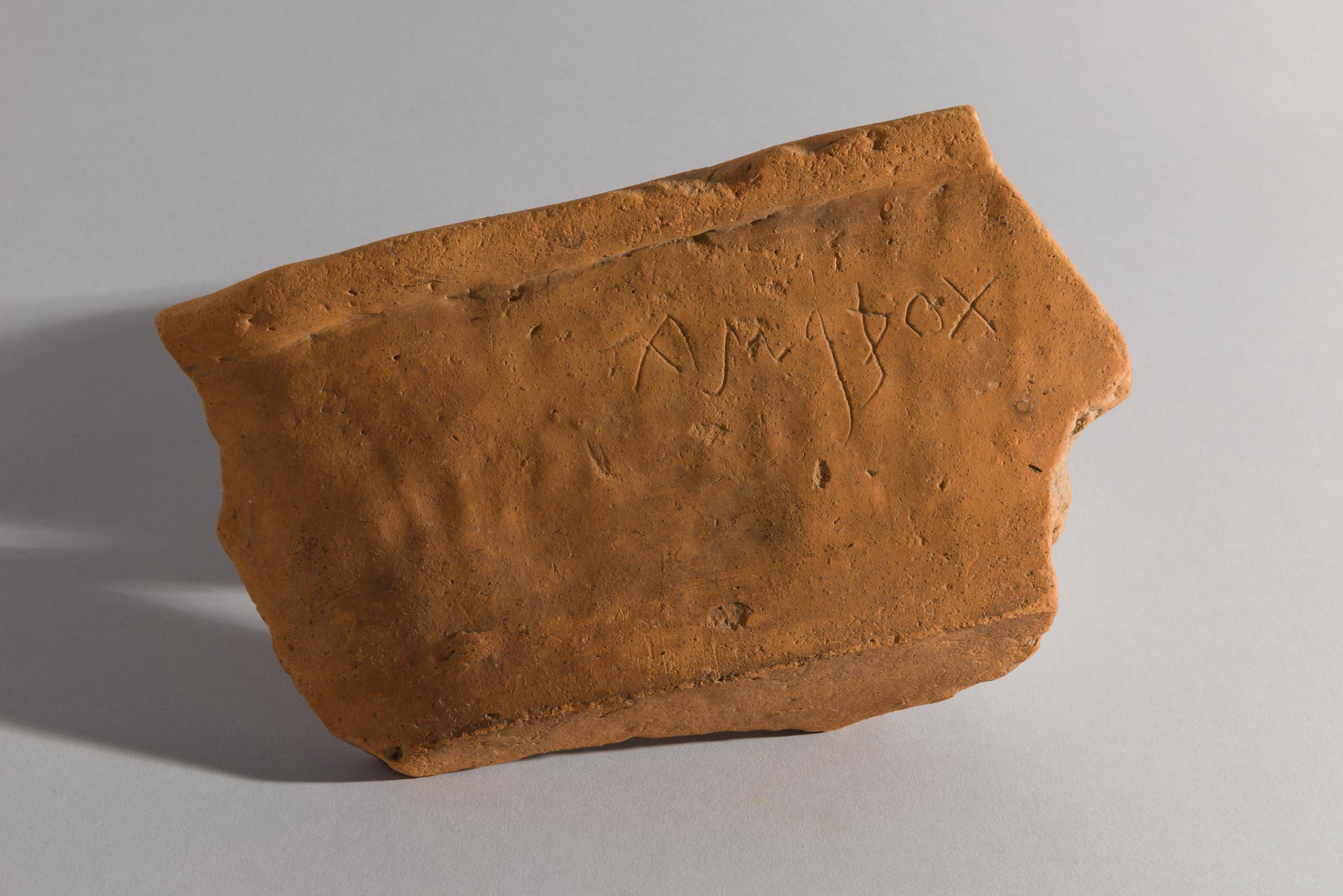 Roman pottery flanged dish with graffito