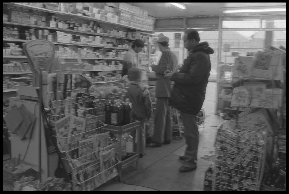 People standing at counter in supermarket, Loudoun Square, Butetown.