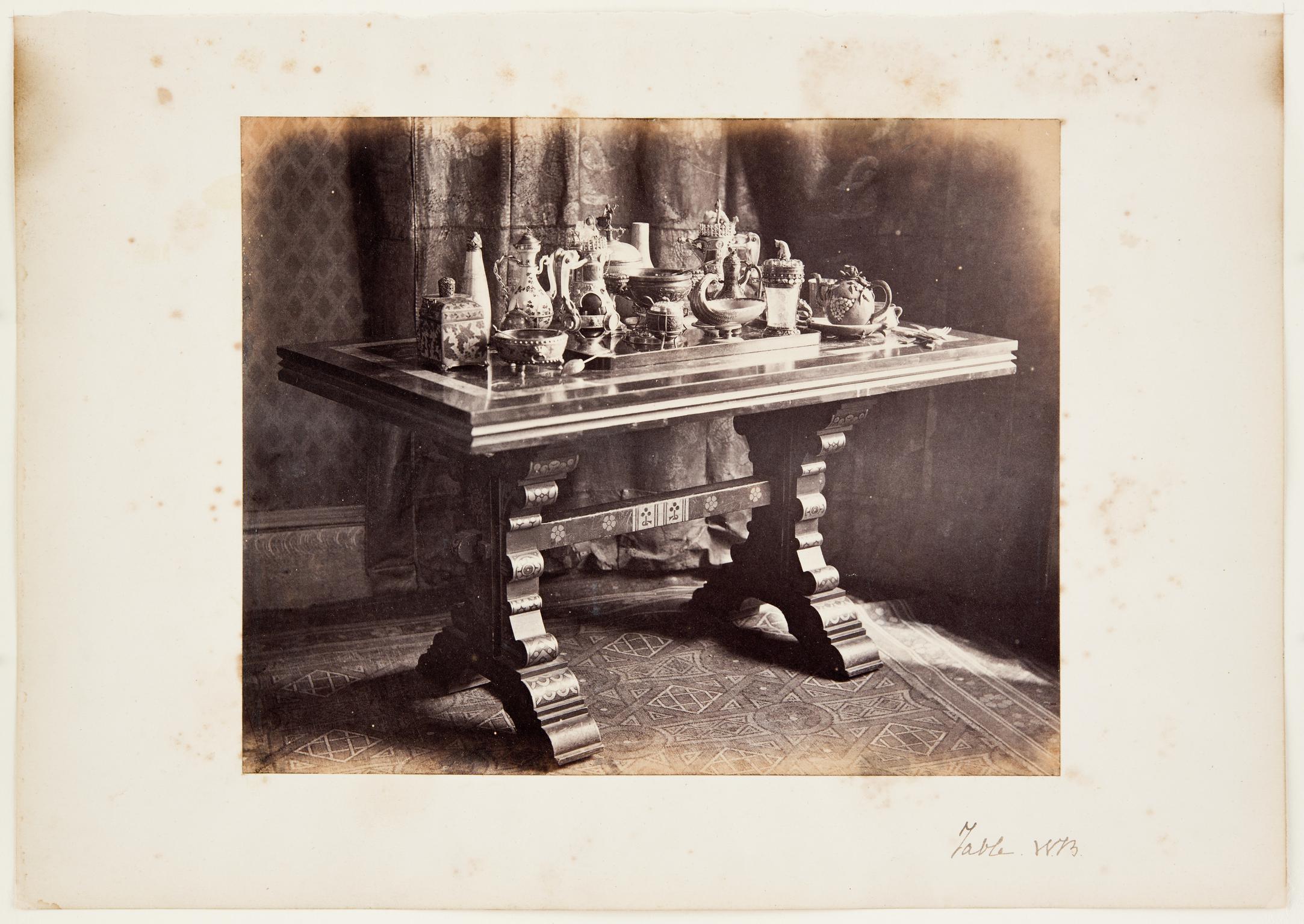 A Table with a Collection of Burges's Metalwork