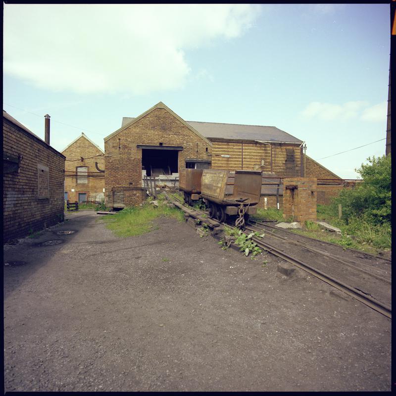 Colour film negative showing a haulage engine and drams, Morlais Colliery. &#039;Morlais&#039; is transcribed from original negative bag.