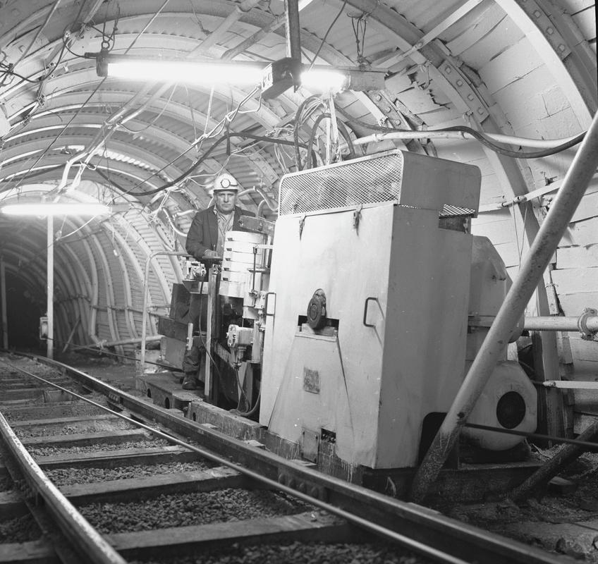 Black and white film negative showing a haulage engine and operator, Oakdale Colliery, May 1980.  &#039;Oakdale May 1980&#039; is transcribed from original negative bag.