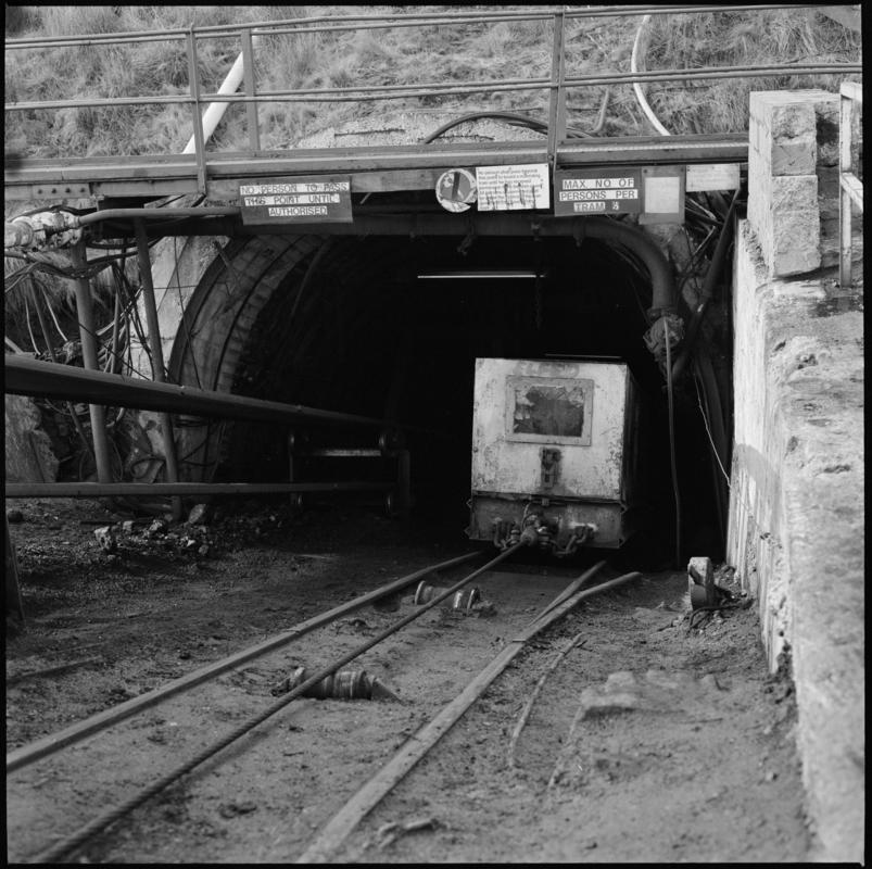 Black and white film negative showing the man riding train descending into the mine, Treforgan Colliery 1979.