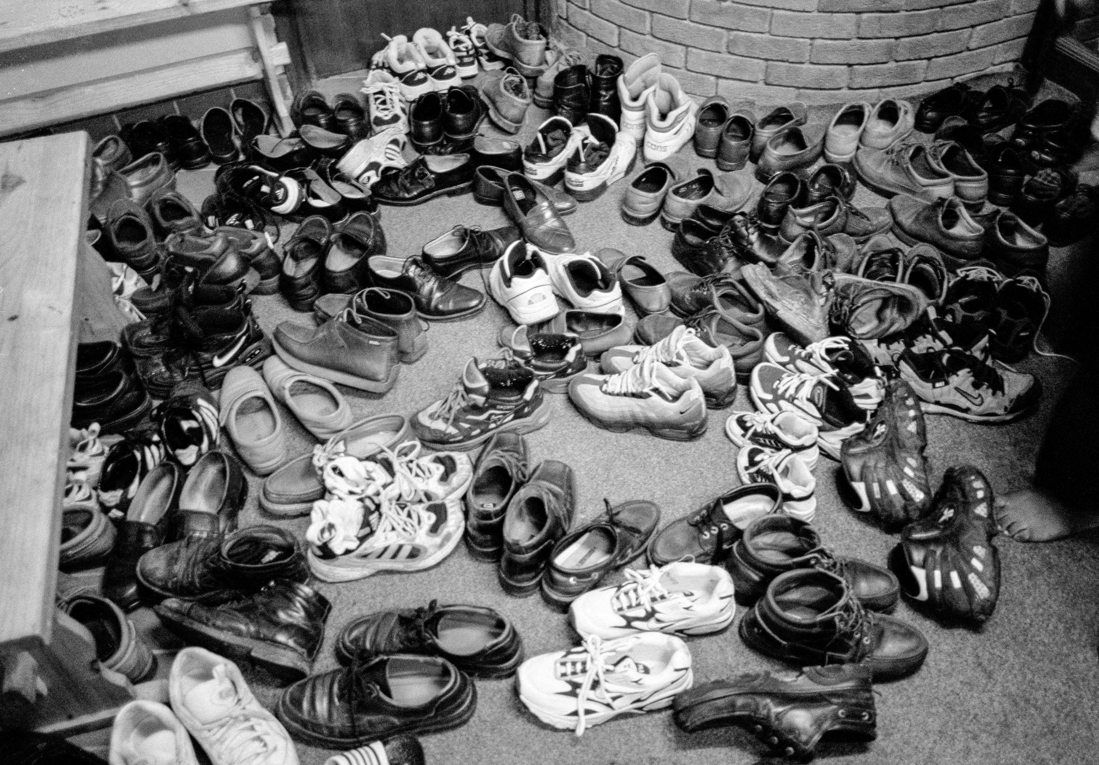 The shoes of the faithful, inside the Alice Street Mosque, Butetown. Cardiff, Wales