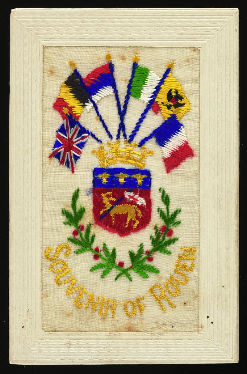 Embroidered silk postcard inscribed Souvenir of Rouen. Sent from France by either Gordon Hobbs or Tom Hardiman during First World War. Undated. Embroidered with town coat of arms and six flags. No message on back.