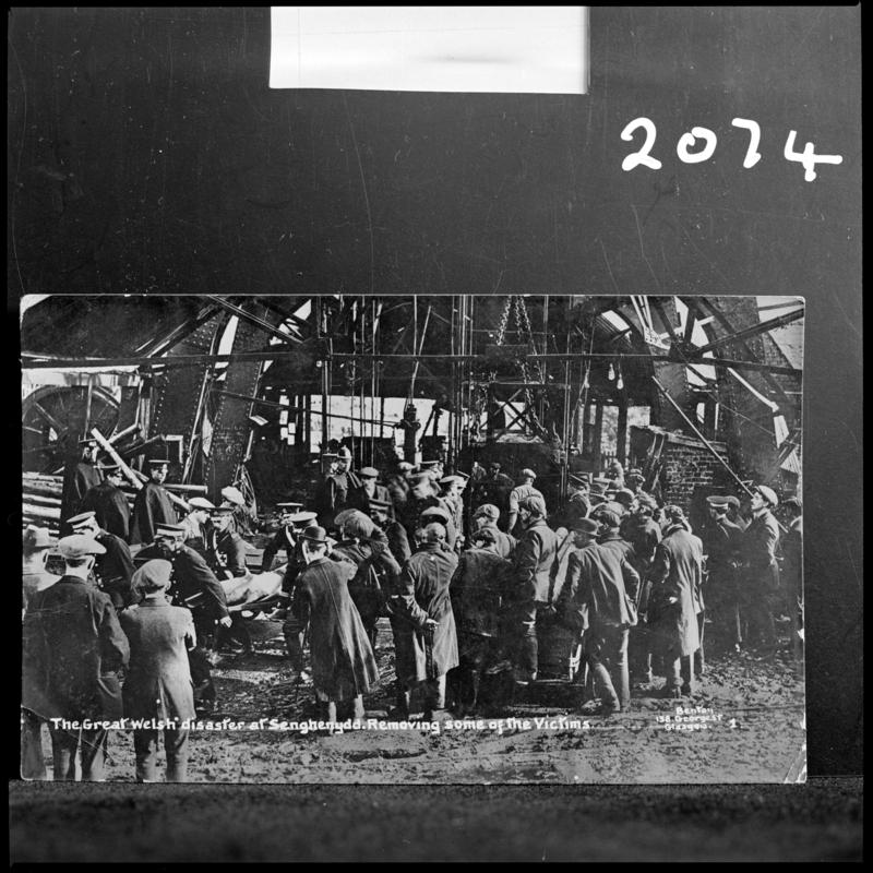 Black and white film negative of a photograph showing the scene at Universal Colliery, Senghenydd after the explosion of 14 October 1913.  Caption on photograph reads &#039;the Great Welsh disaster at Senghenydd.  Removing some of the victims&#039;.