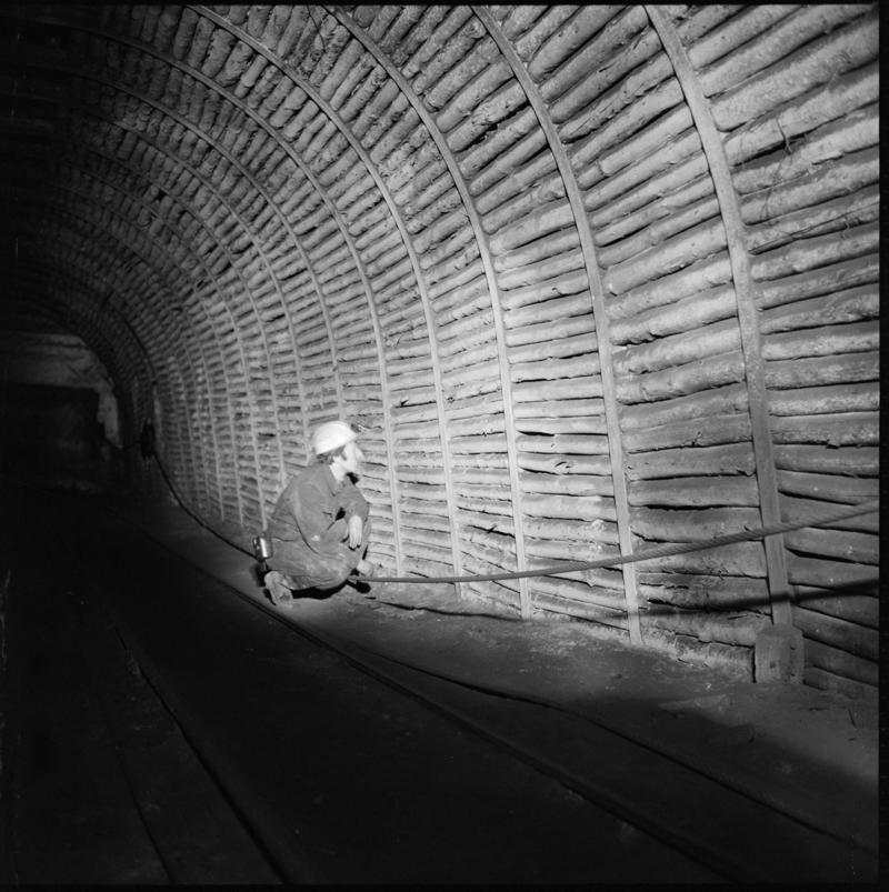 Black and white film negative a man underground, Tymawr Colliery 21 December 1976.  &#039;Ty Mawr 21/Dec/76&#039; is transcribed from original negative bag.