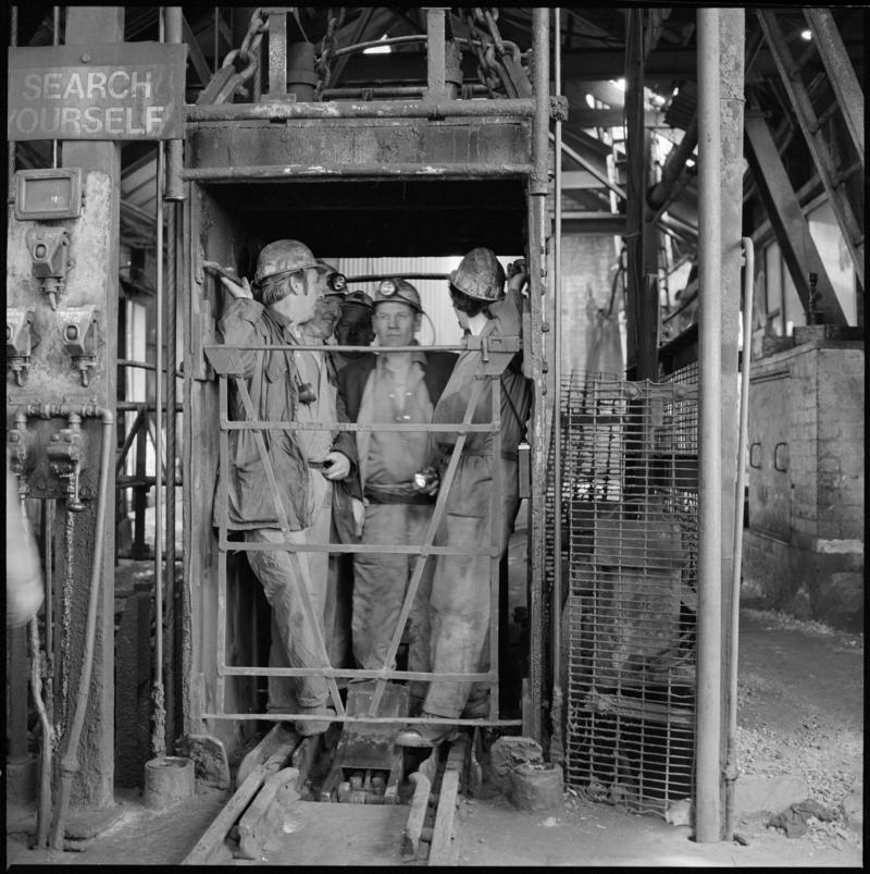 Black and white film negative showing men in the cage at pit top, Morlais Colliery 13 May 1981.  &#039;Morlais 13/5/81&#039; is transcribed from original negative bag.