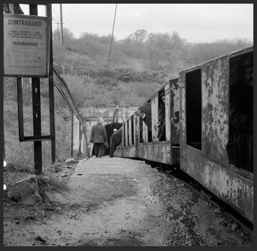 Black and white film negative showing a manriding train at the entrance of the mine, Cwmgwili Colliery.