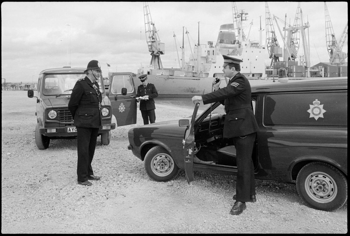 British Transport (Docks) Police at Queen Alexandra Docks, Cardiff. The policeman wearing a helmet is PC William Power, the longest serving policeman (34 years) who started with the Great Western Railway. Sergeant Peter Cooper is on the radio on the right.