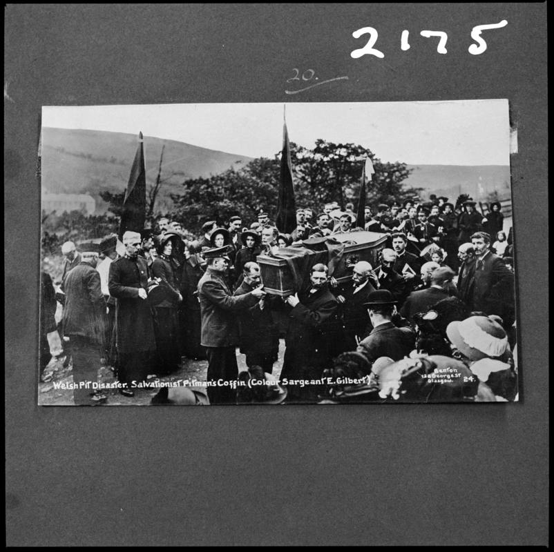Black and white film negative of a photograph showing a coffin surrounded by a crowd, 1913.  Caption on photograph reads &#039;Welsh pit disasters.  Salvationist Pitman&#039;s Coffin (Colour Sargeant E. Gilbert)&#039;.  &#039;Sen 1913&#039; is transcribed from original negative bag.