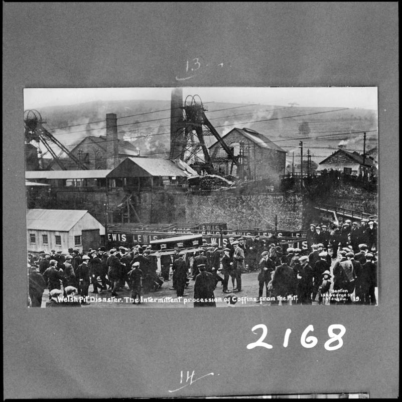 Black and white film negative of a photograph showing the scene at Universal Colliery, Senghenydd following the disaster of 14 October 1913. Caption on photograph reads &#039;Welsh pit disaster.  The intermittent procession of coffins from the pit&#039;.  &#039;Sen 1913&#039; is transcribed from original negative bag.