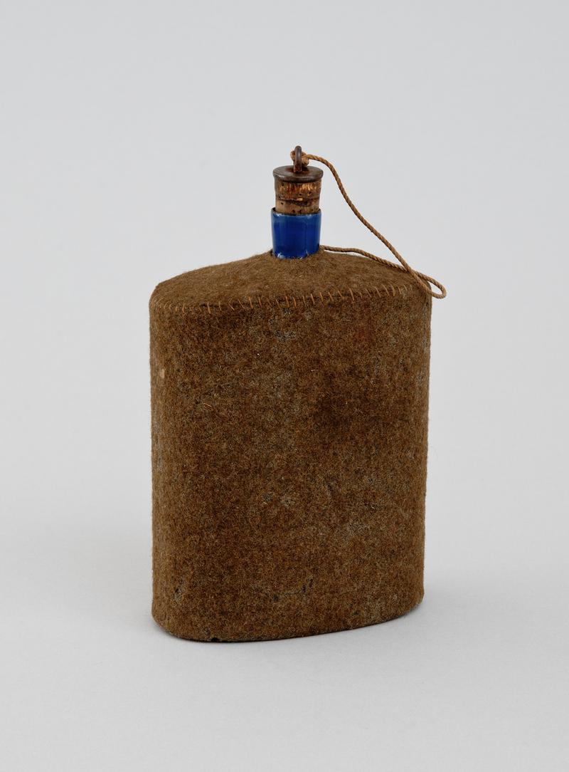 Blue enamelled, felt covered water bottle with a cork stopper attached