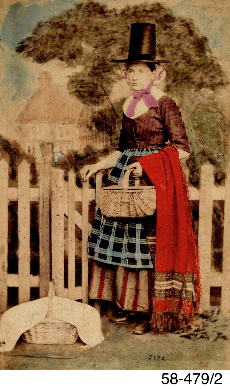 Tinted photograph of a woman in Welsh costume