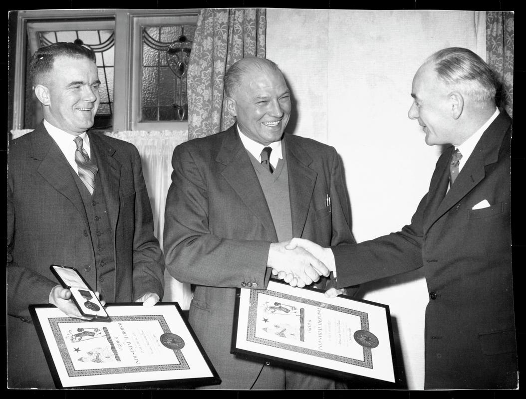 Mr. J. Arthur Jones and William J. Read being presented with their Daily Herald Order of Industrial Heroism certifcates and medal on the 24th May 1958 at Pontypool Rygby Football Club