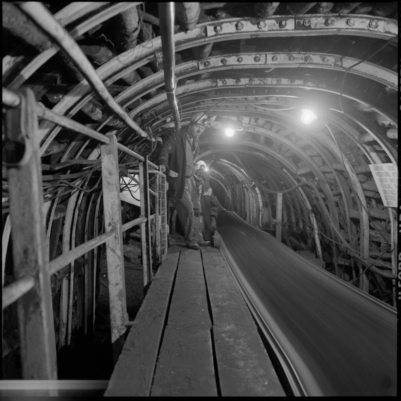 Black and white film negative showing men beside a conveyor, Celynen North Colliery 1978-9.  &#039;Celynen North 1978-9&#039; is transcribed from original negative bag.