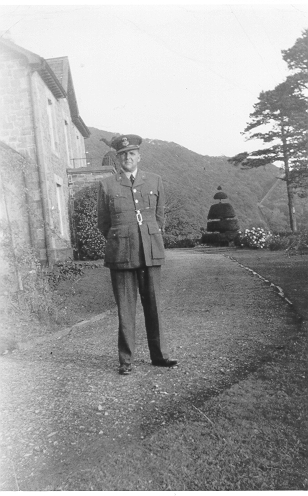 Dinorwig Quarry Hospital. Malcolm Pugh (husband of Vivian Hughes&#039; aunt) outside DQH. Note entrance porch on front of building, and the &#039;A&#039; incline in the background.