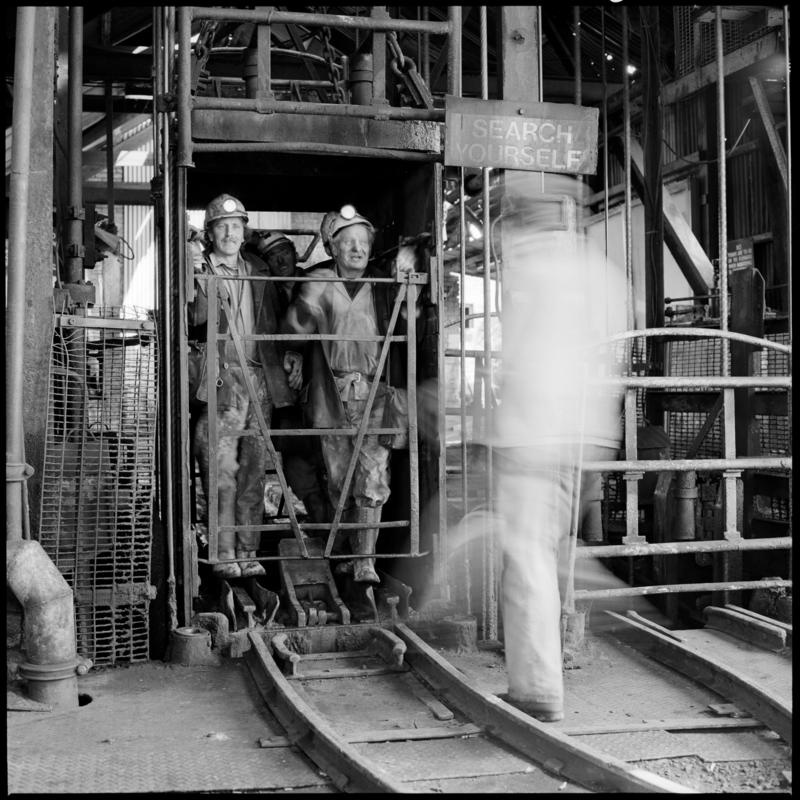 Black and white film negative showing miners in the cage, Morlais Colliery 13 May 1981.  &#039;Morlais 13/5/81&#039; is transcribed from original negative bag.