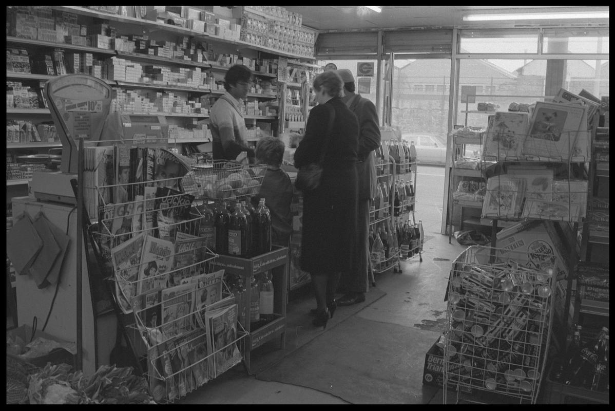 People standing at counter in supermarket, Loudoun Square, Butetown.