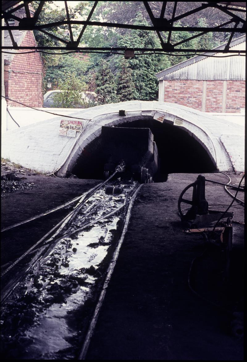 Colour film slide showing a journey of drams being lowered into the slant, Ammanford Colliery 1974.
