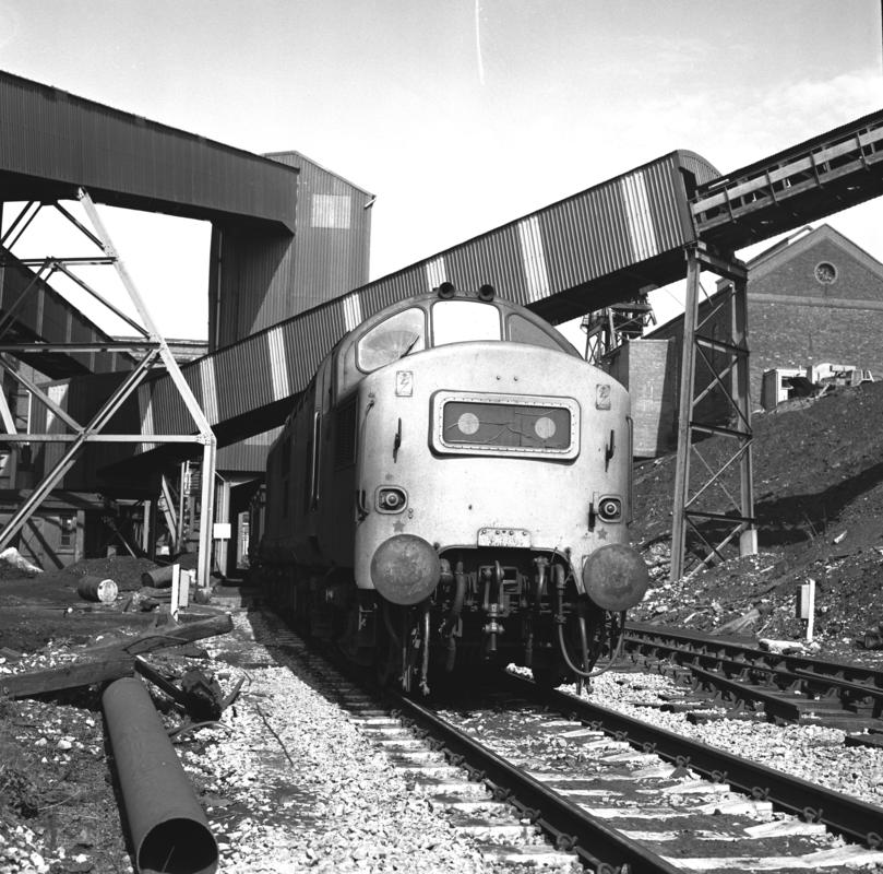 Black and white film negative showing a locomotive passing through Oakdale Colliery, 16 April 1981.  &#039;Oakdale 16 Apr 1981&#039; is transcribed from original negative bag.