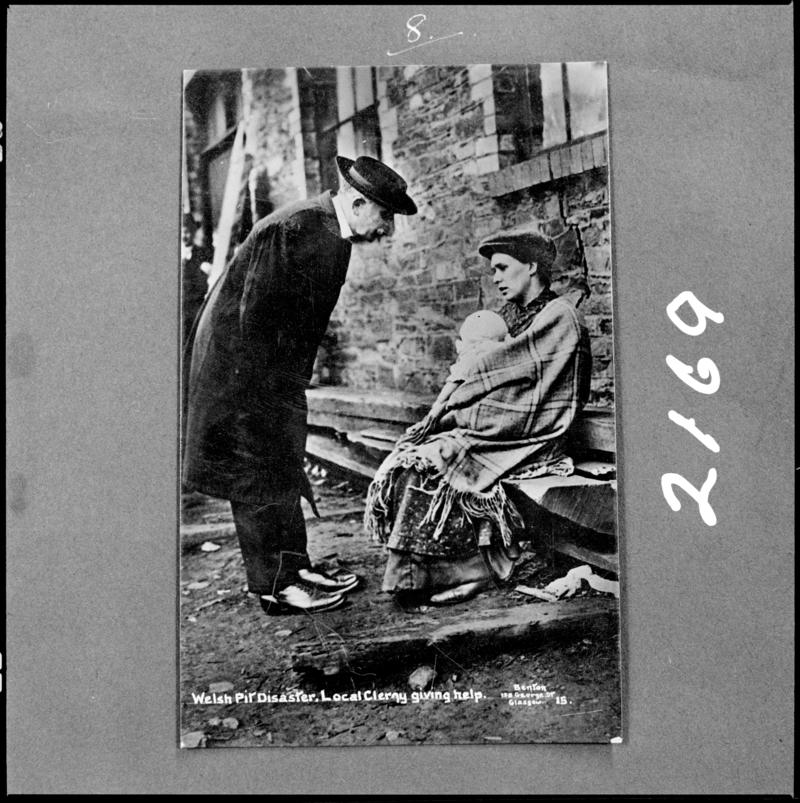 Black and white film negative of a photograph showing a local clergyman giving help, following the Universal Colliery disaster of 14 October 1913.  &#039;Sen 1913&#039; is transcribed from original negative bag.