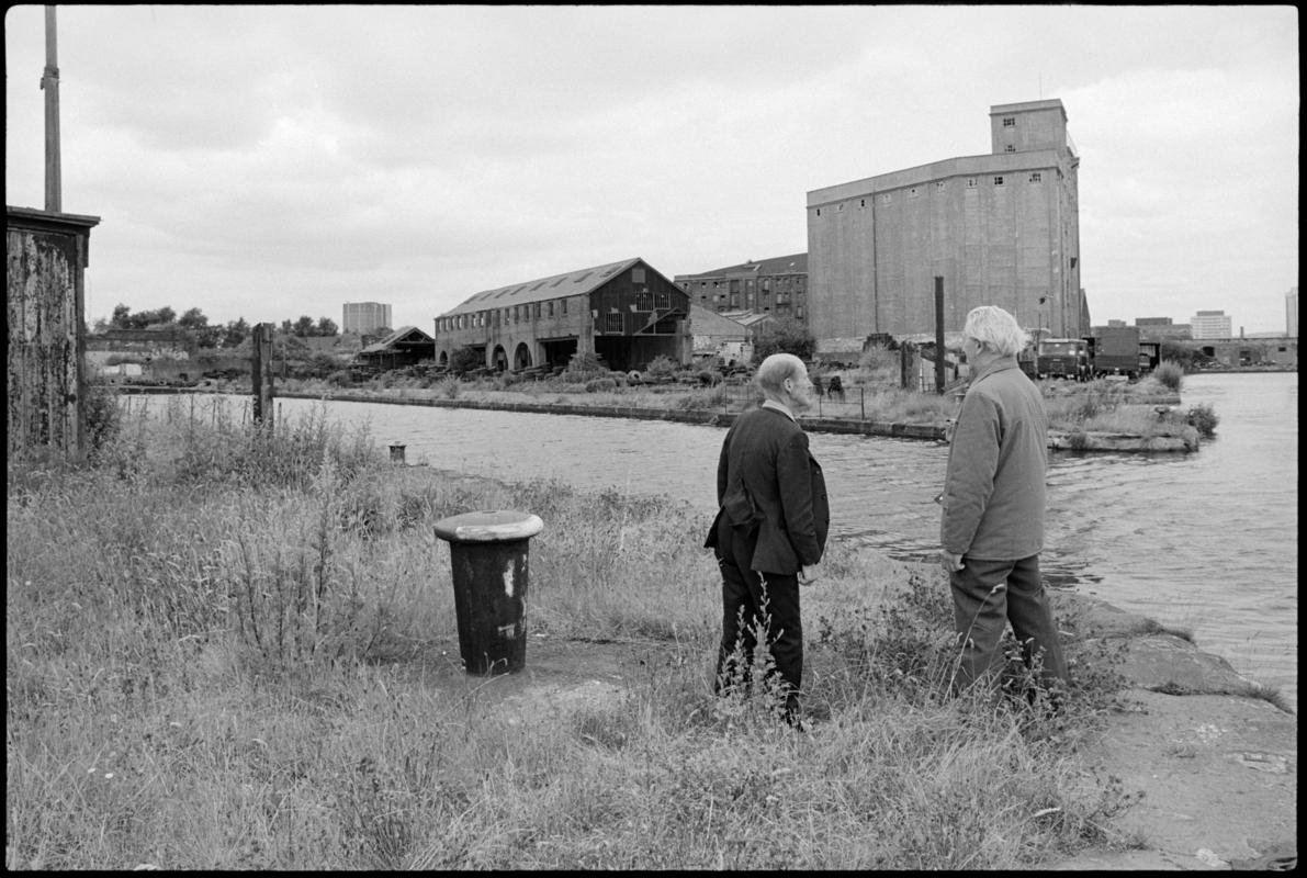 View of Hill&#039;s Dry Dock, Bute East Dock, with Mr R Coakley and Mr Jim Sullivan in the foreground, both of whom used to work there. Mr Coakley worked at the docks for 50 years, of which 20 years were at Junction Dry Dock and seven years at Hill&#039;s.