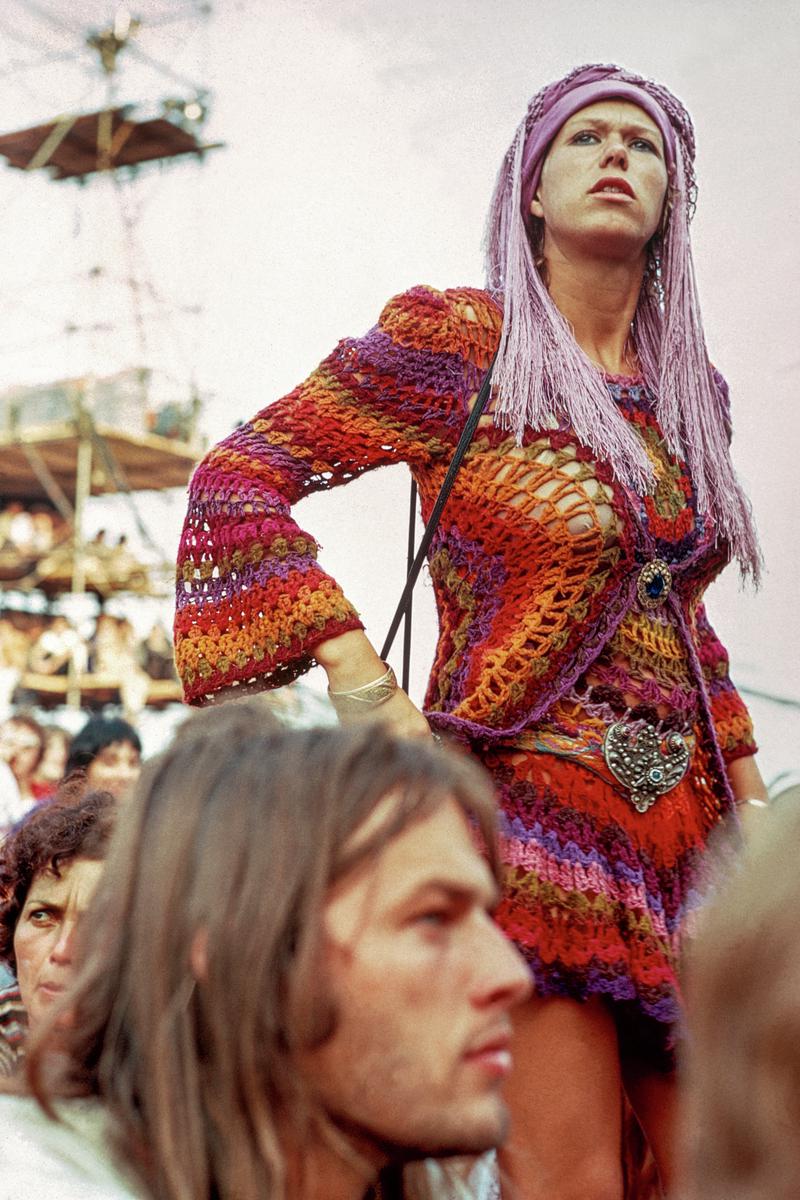 GB. ENGLAND. Isle of Wight Festival. Pop festivals bring out the wildest forms of dress sense. In the foreground sits Pink Floyd guitarist David Gilmour. 1969.