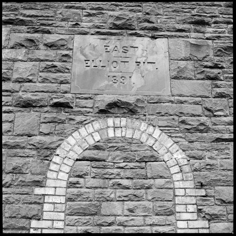 Black and white film negative showing an engraved stone on the exterior of the engine house reading &#039;East Elliot Pit 1891&#039;. &#039;East Elliot&#039; is transcribed from original negative bag.