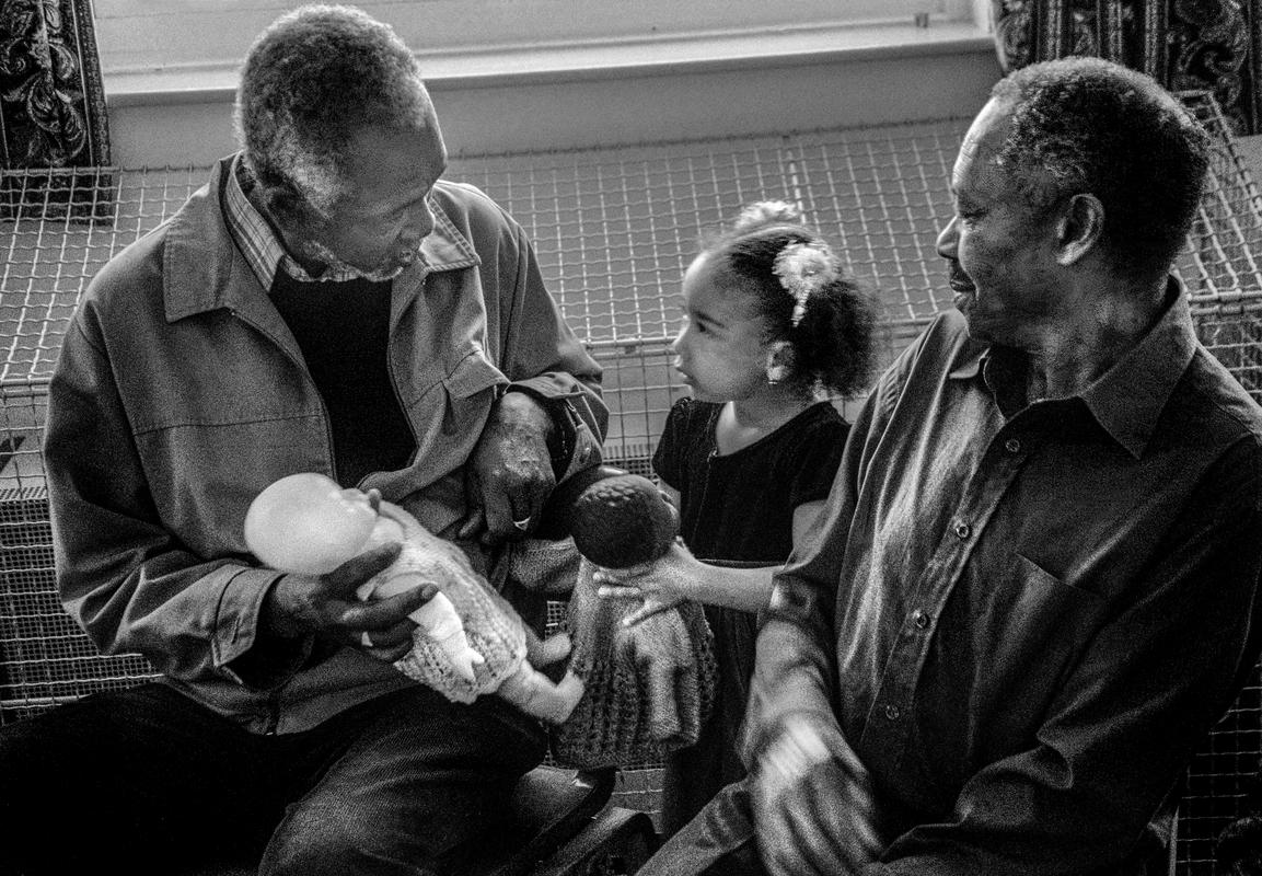 GB. WALES. Cardiff. Butetown - once know as &#039;Tiger Bay&#039;. Carl Alexis and granddaughter in St Paul&#039;s, Loudoun Square. 2003.