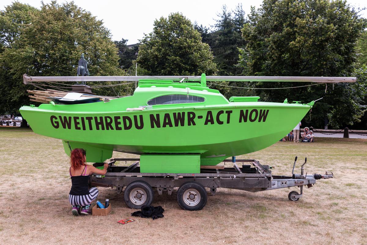 Extinction Rebellion Protest in Cardiff - Civic Centre, Museum and City Hall Lawn. Green Yachts with Protest Slogans painted on them.