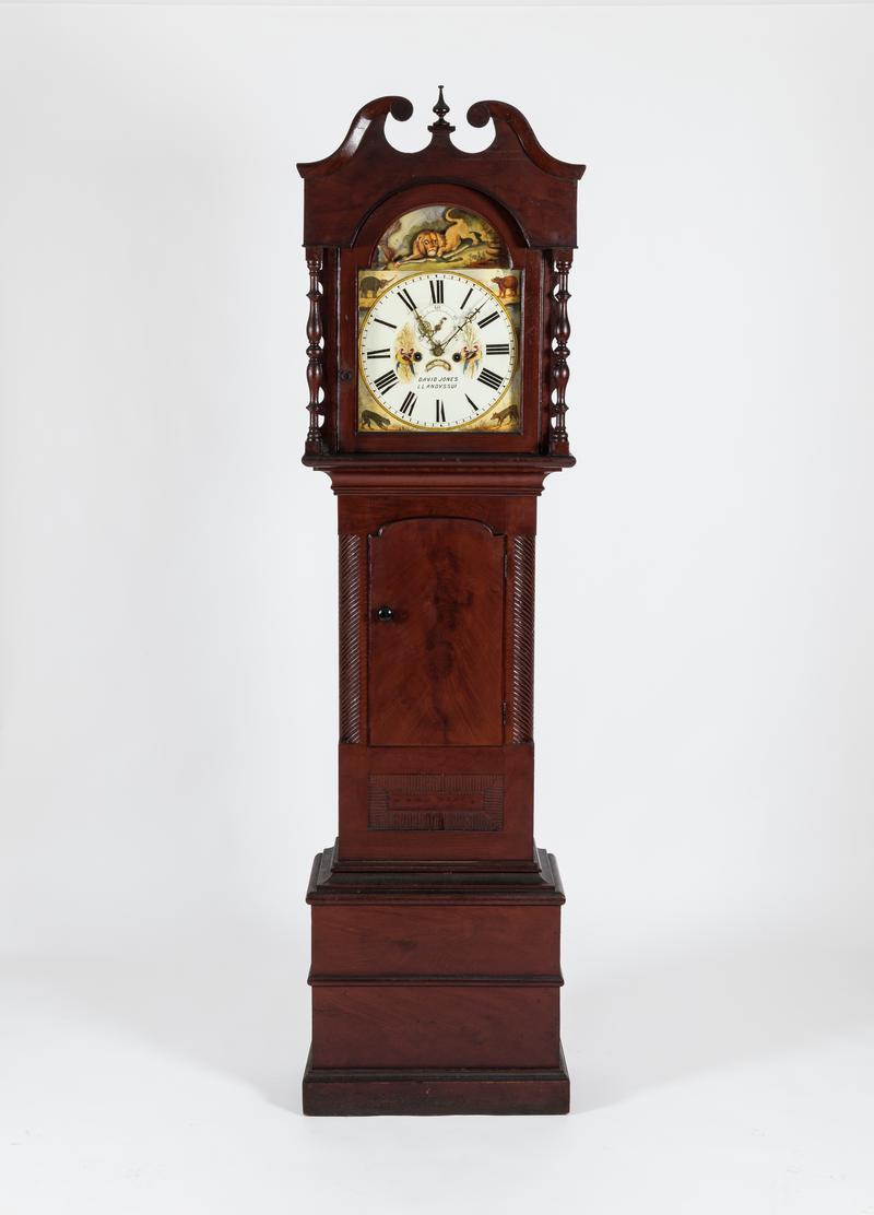 Longcase clock with lion illustration.