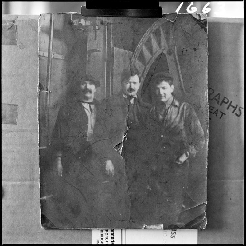 Black and white film negative showing a photograph of three men stood in front of a ?waddle fan, Deep Navigation Colliery.  Appears to be identical to 2009.3/3053.