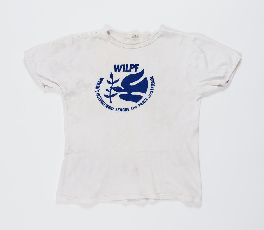 White t-shirt with blue logo for &#039;WILPF &#039;Women&#039;s International League for Peace and Freedom&#039;. Worn by Thalia Campbell in 1995 on the &#039;Sew to Say&#039; march from Helsinki to Beijing.