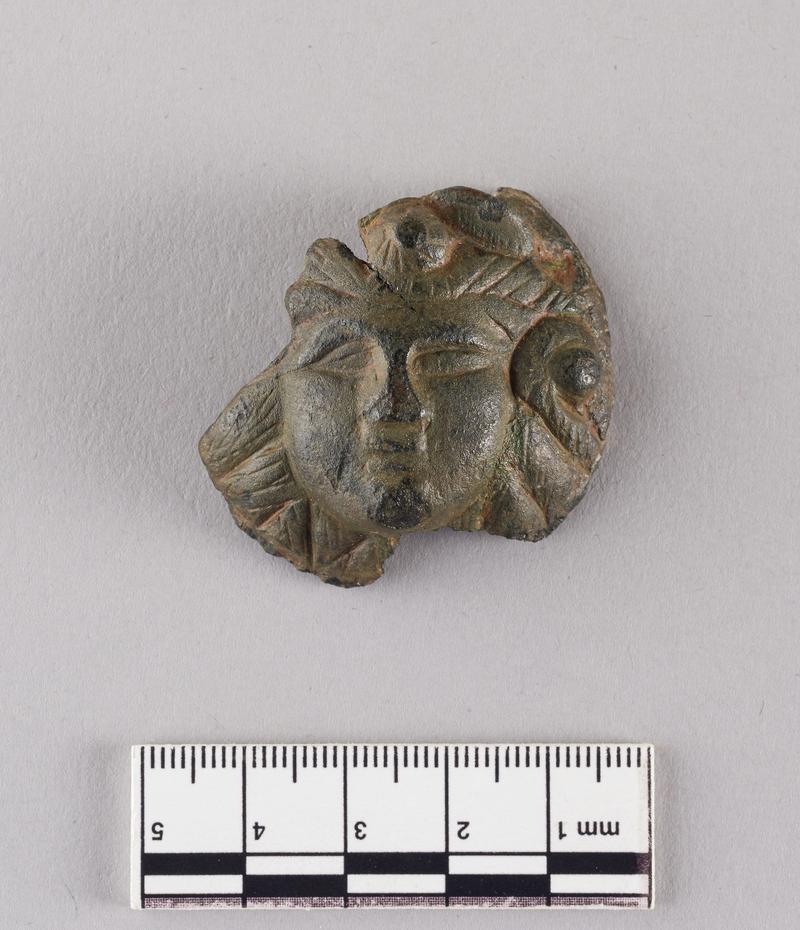 Roman copper alloy furniture fitting, Medusa mask.