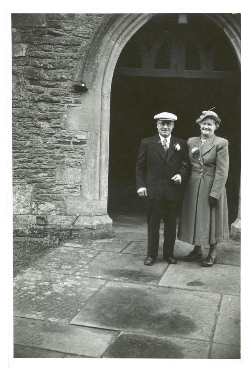 Photograph of Mr &amp; Mrs William Targett outside a church at a wedding.