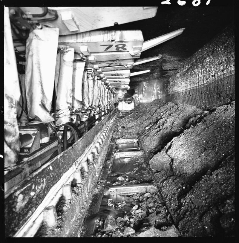 Black and white film negative showing chainless haulage on the face with Gullick Dobson powered supports, Betws Mine.