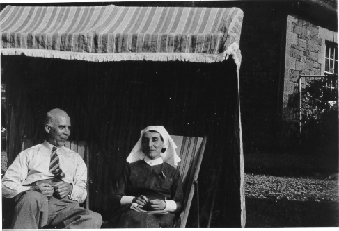 Dinorwig Quarry Hospital. Griffith Samuel Hughes and a nurse sitting in an open fronted tent outside DQH