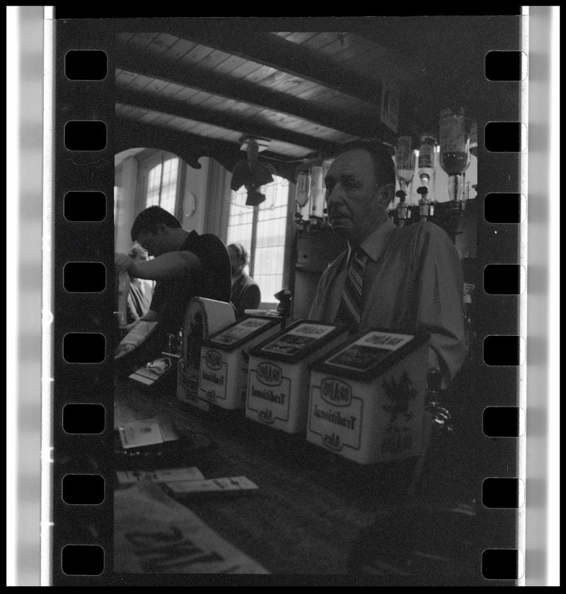 Barman serving drinks in the Dowlais Pub.